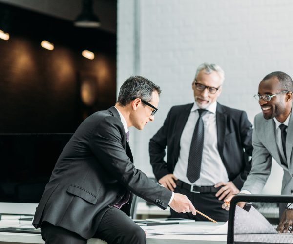 multiethnic businessmen discussing new business strategy on meeting in office